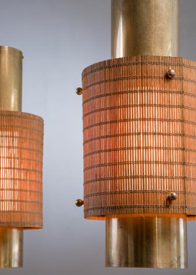 Paavo Tynell Pair of Paavo Tynell brass and wood pendant lamps