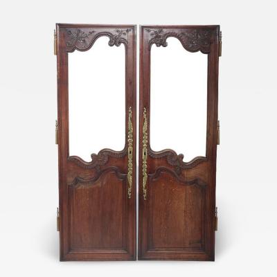Pair French oak 19th Century cabinet doors with glass panel and brass hardware