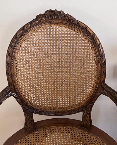 Pair Louis XVI Style Carved Walnut Arm Chairs with Caned Back Seat