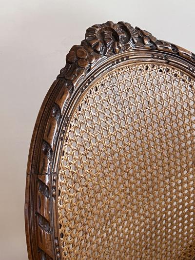 Pair Louis XVI Style Carved Walnut Arm Chairs with Caned Back Seat