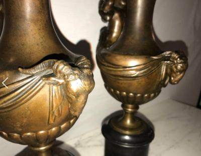 Pair of 19th Century Urns on Marble Stands Bearing Cherubs and Rams Heads