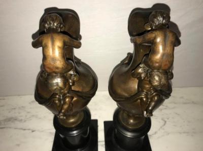 Pair of 19th Century Urns on Marble Stands Bearing Cherubs and Rams Heads