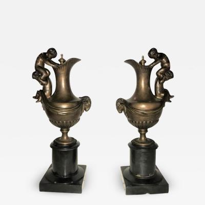 Pair of 19th Century Urns on Marble Stands Bearing Cherubs and Rams Heads