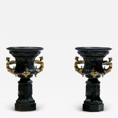 Pair of Antique French Rococo Style Black Iron Urns Adorned with Brass Figures