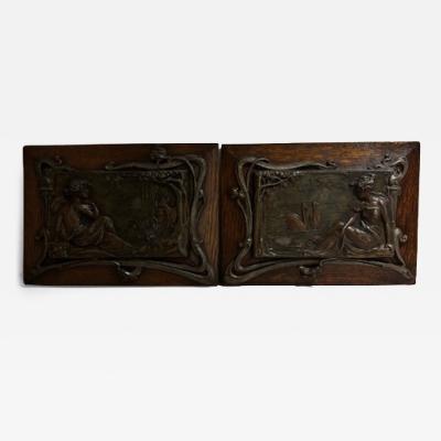 Pair of Art Nouveau Metal and Oak Figural Wall Plaque
