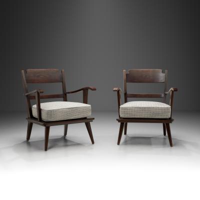 Pair of Dark Stained Pine Armchairs Europe First half of the 20th century