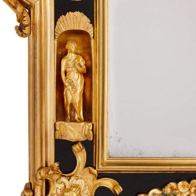Pair of English gilt bronze and ebonised wood mirrors