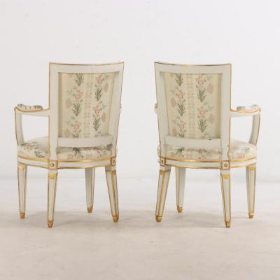 Pair of French Louis XIV style painted and gilt open arm chairs C 1990 
