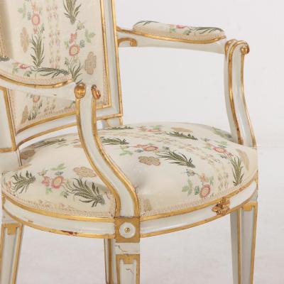 Pair of French Louis XIV style painted and gilt open arm chairs C 1990 