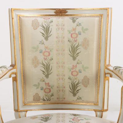 Pair of French Louis XIV style painted and gilt open arm chairs C 1990 