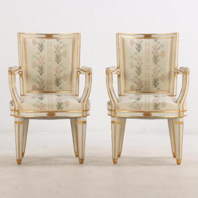 Pair of French Louis XIV style painted and gilt open arm chairs C 1990 