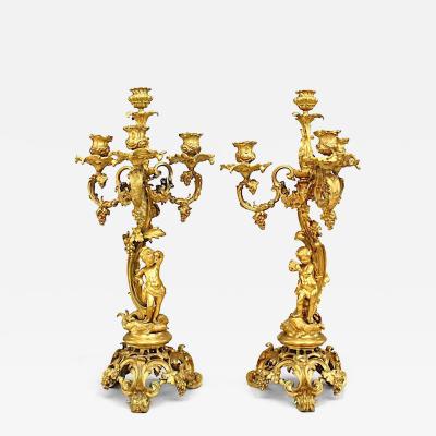 Pair of French Louis XV Style Bronze Dore Four Arm Cupid Candelabras