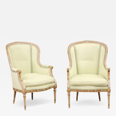 Pair of French Louis XVI Style 1900s Painted and Parcel Gilt Berg res Chairs
