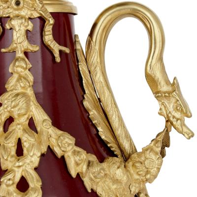 Pair of French Neoclassical style red t le and gilt bronze vases