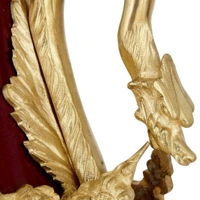 Pair of French Neoclassical style red t le and gilt bronze vases
