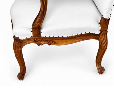 Pair of French Regence Style Armchairs in carved Walnut 19th Century