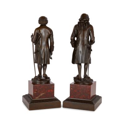 Pair of French patinated bronze sculptures of Voltaire and Rousseau