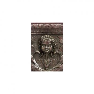 Pair of Italian Renaissance style carved walnut wall plaques with cupid head