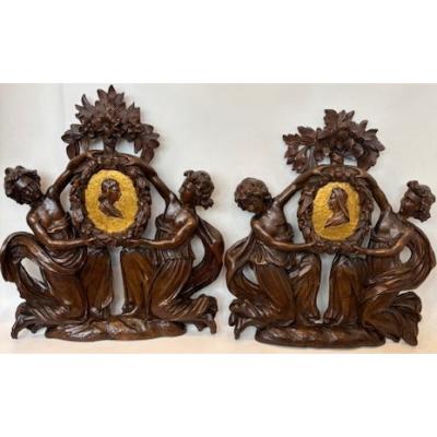 Pair of Italian wall plaques of 2 kneeling figures hold an oval frame portrait