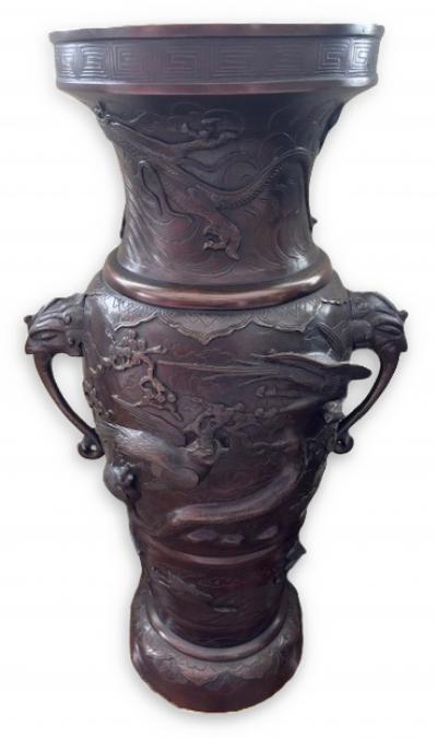 Pair of Japanese tall bronze floor vases with handles and bird relief