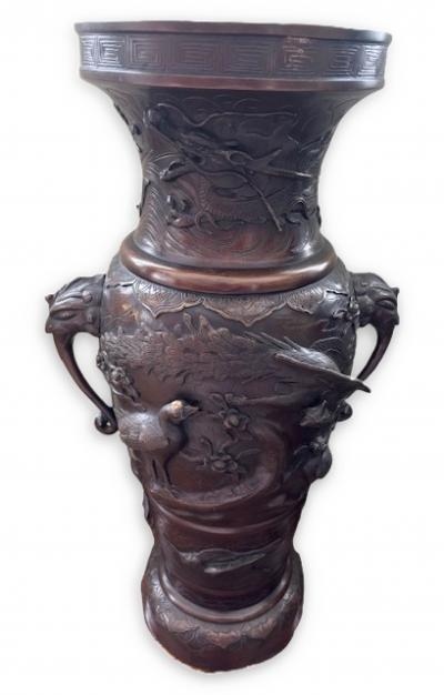Pair of Japanese tall bronze floor vases with handles and bird relief