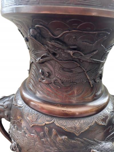 Pair of Japanese tall bronze floor vases with handles and bird relief