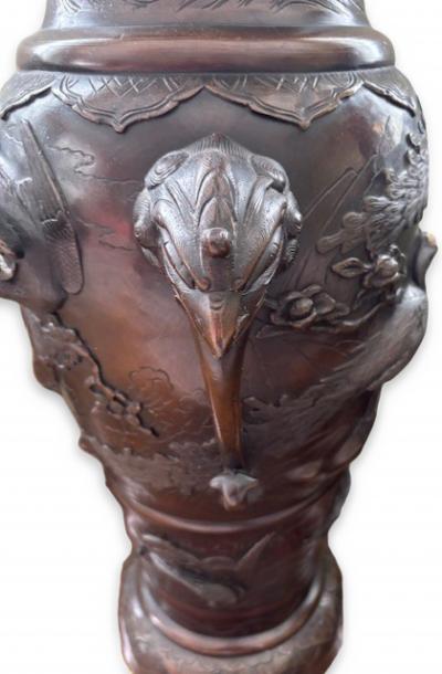 Pair of Japanese tall bronze floor vases with handles and bird relief