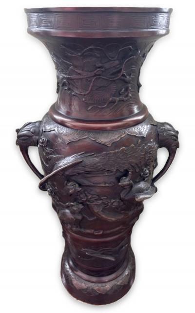 Pair of Japanese tall bronze floor vases with handles and bird relief