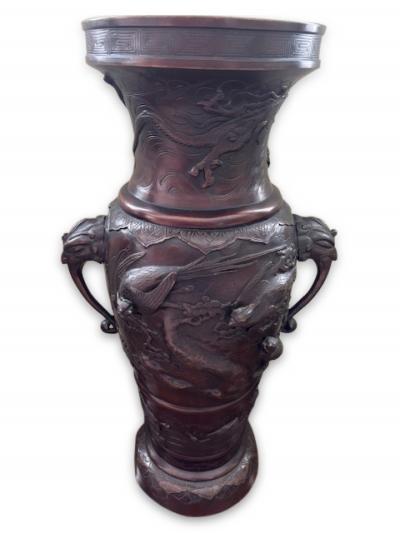 Pair of Japanese tall bronze floor vases with handles and bird relief