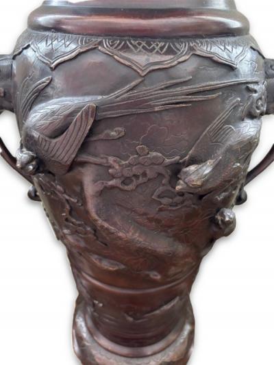 Pair of Japanese tall bronze floor vases with handles and bird relief