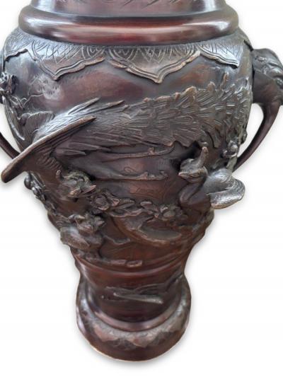 Pair of Japanese tall bronze floor vases with handles and bird relief