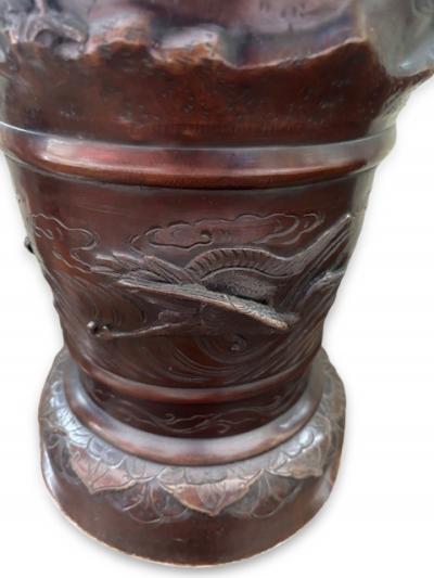 Pair of Japanese tall bronze floor vases with handles and bird relief