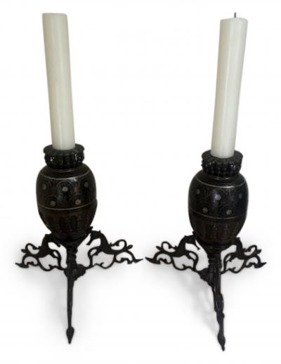 Pair of Middle Eastern candlesticks with brass inlay and 3 horse base