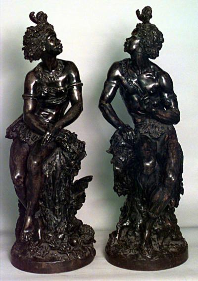 Pair of Moreau French Victorian bronze seated nubian figures with feathers in ha