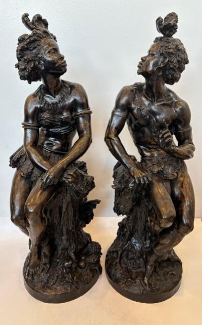 Pair of Moreau French Victorian bronze seated nubian figures with feathers in ha