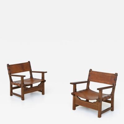 Pair of Spanish brutalist lounge chairs oak and saddle leather Spain 1960