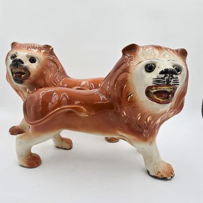 Pair of Staffordshire Striding Lions