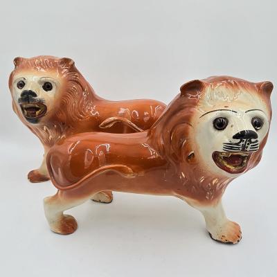 Pair of Staffordshire Striding Lions