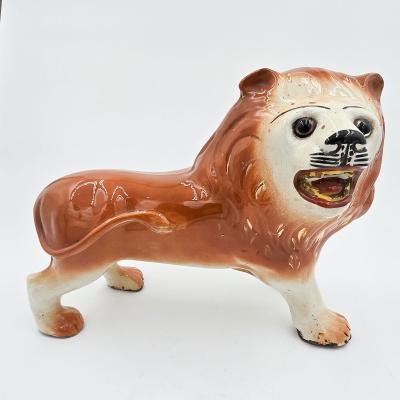 Pair of Staffordshire Striding Lions