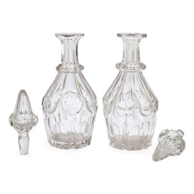 Pair of antique English cut glass decanters with silver plated stand