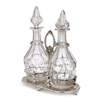 Pair of antique English cut glass decanters with silver plated stand