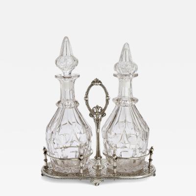Pair of antique English cut glass decanters with silver plated stand