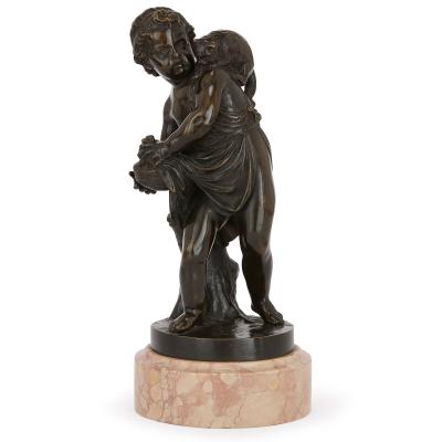 Pair of antique bronze figures of cherubs and animals