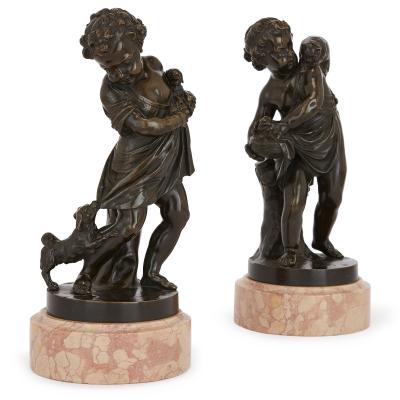 Pair of antique bronze figures of cherubs and animals