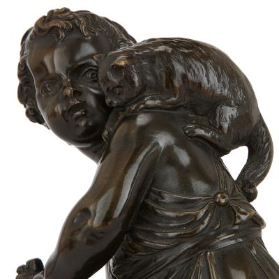 Pair of antique bronze figures of cherubs and animals