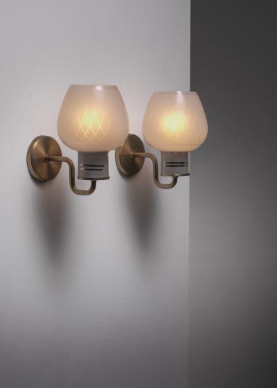 Pair of brass and glass wall lamps
