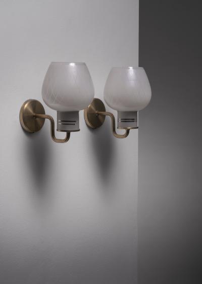 Pair of brass and glass wall lamps
