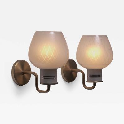 Pair of brass and glass wall lamps