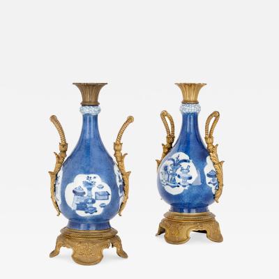 Pair of gilt bronze and Chinese blue and white porcelain vases