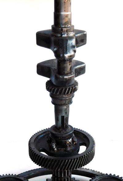 Pair of industrial cast iron gear wheel tables with circular glass tops